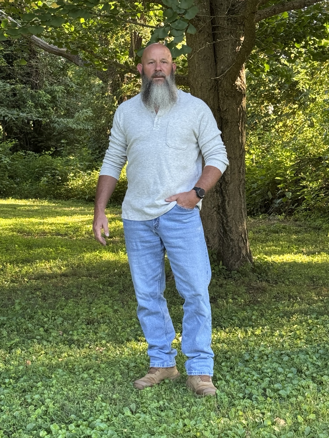 C. Mark Taylor standing beneath a tree
